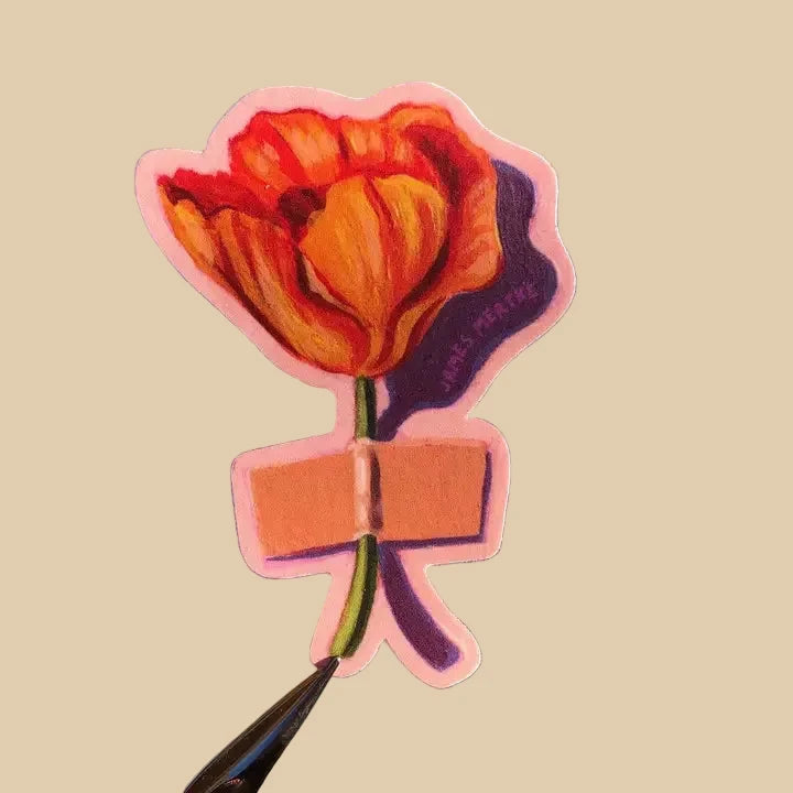 This sticker depicts a painting of an orange California poppy that has been taped to a surface by its stem.