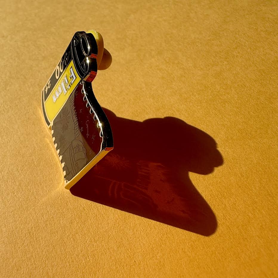 This image features the shadow of the pin and highlights the screen-printed detail on the transparent panel.