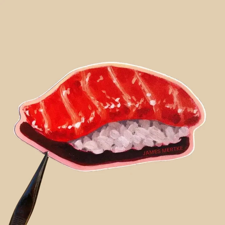 This sticker features a painting of salmon nigiri. An orange piece of fish lays over rice.