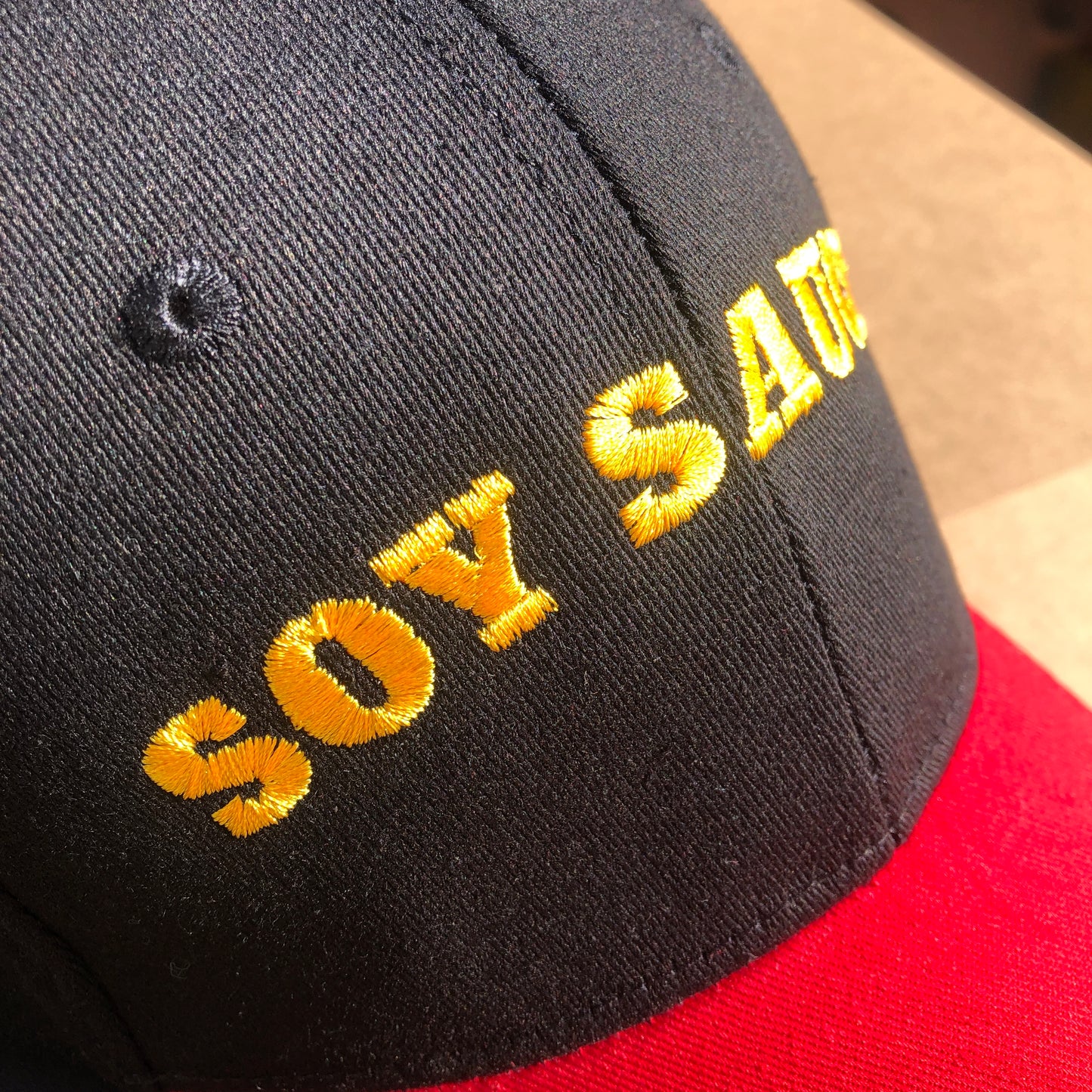 A close up shot of the embroidered soy saucedesign.