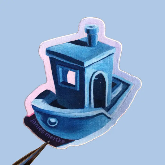 This sticker depicts a painting of Benchy, a blue tugboat used to calibrate a 3D printer.