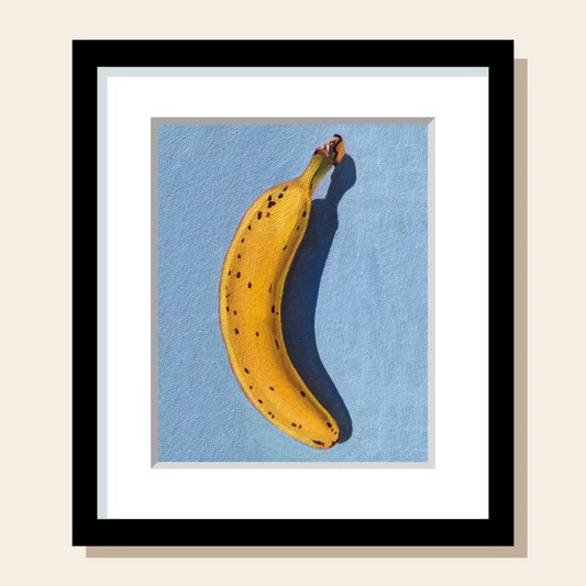 This painting art print features a banana on a blue surface painted in a realistic style.