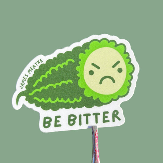 This sticker features an illustrated piece of  bitter melon with a grumpy face on its cross section. The phrase "BE BITTER" is written along the bottom.
