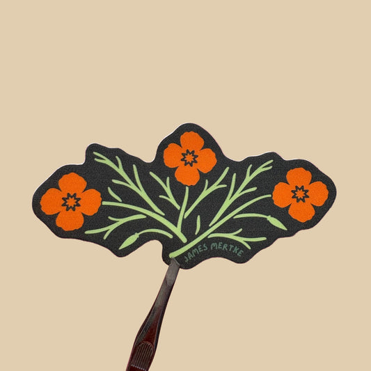 A die-cut sticker featuring three orange poppy flowers with light green stems on a dark green background.