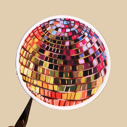 A sticker of a red purple and yellow disco ball