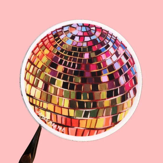 This sticker features a painting of a disco ball with pink, purple, and yellow colors. 
