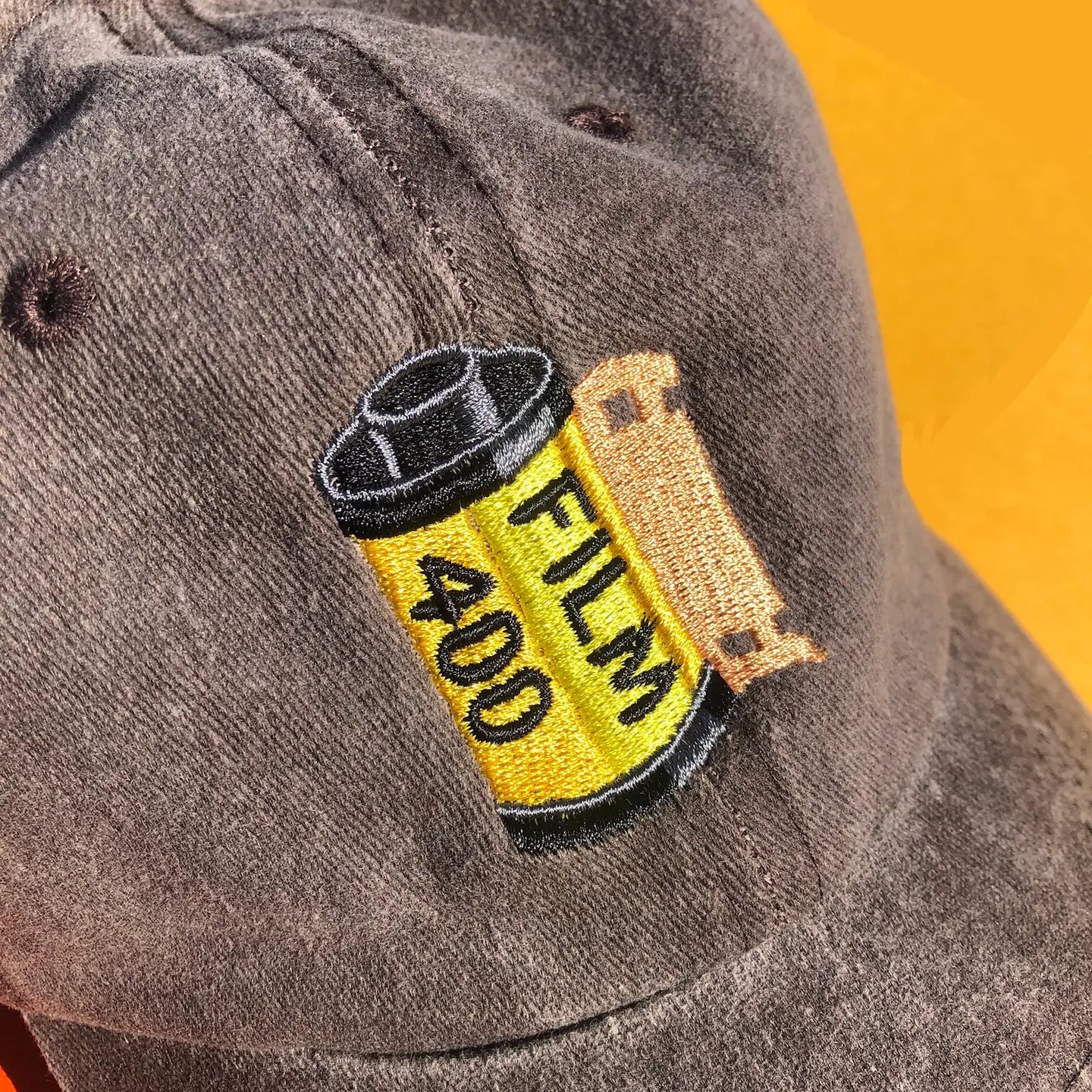 A close up of the embroidered film canister design.
