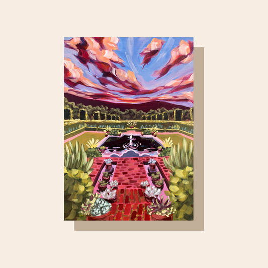 This art print features a view of Filoli Garden. With greenery and a brick pathway in the foreground, a fountain and hedges in the middle, and purple mountains and dramatic clouds in the background, this art print will draw you into the scene.