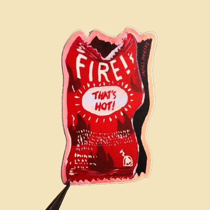 This sticker depicts a painting of a red hot sauce packet. "FIRE" is written at the top and "That's Hot" is written as a joke in the middle.