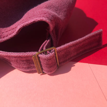 A close up shot of the back of the hat showing the metal buckle that makes the size of the hat adjustable.