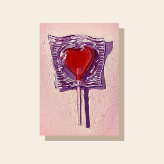 This art print features a red heart lollipop with its wrapper. It casts a dramatic purple shadow.