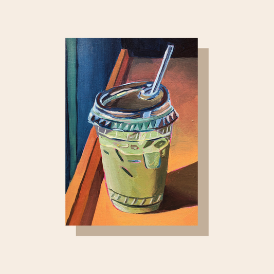 This art print features an iced matcha latte served in a plastic cup with a lid and straw. It sits on Ann orange surface with a dark blue background.