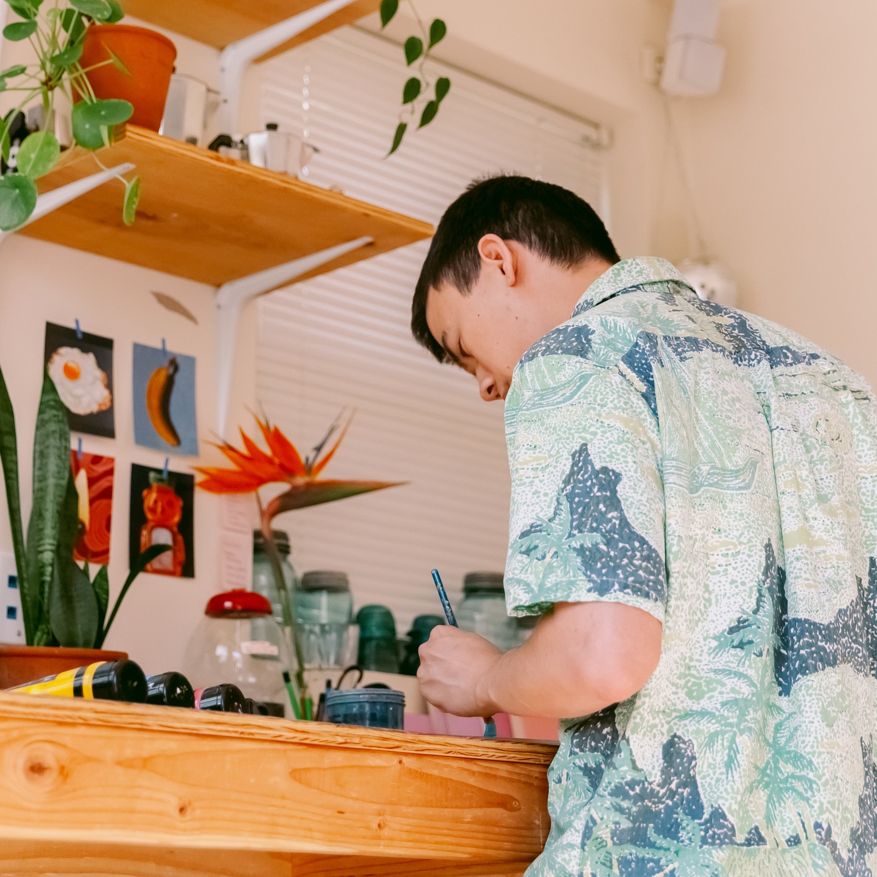 A low angle shot catches James Mertke in action as he works on a painting.