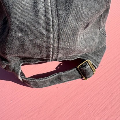 Close up of the adjustable size buckle on the back of the hat.