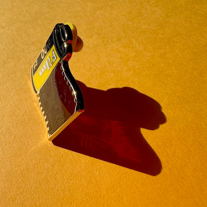 This image features the shadow of the pin and highlights the screen-printed detail on the transparent panel. 