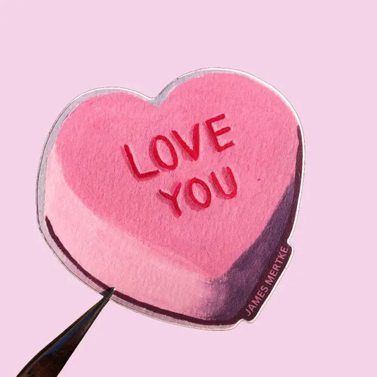 This sticker features a pink conversation heart candy with "LOVE YOU" written in red.
