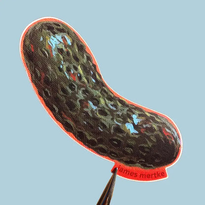 This sticker depicts a painting of a whole pickle with an orange outline.