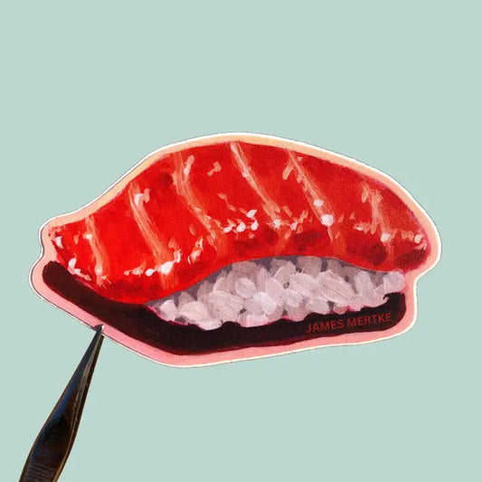 This sticker features a painting of salmon nigiri. An orange piece of fish lays over rice.