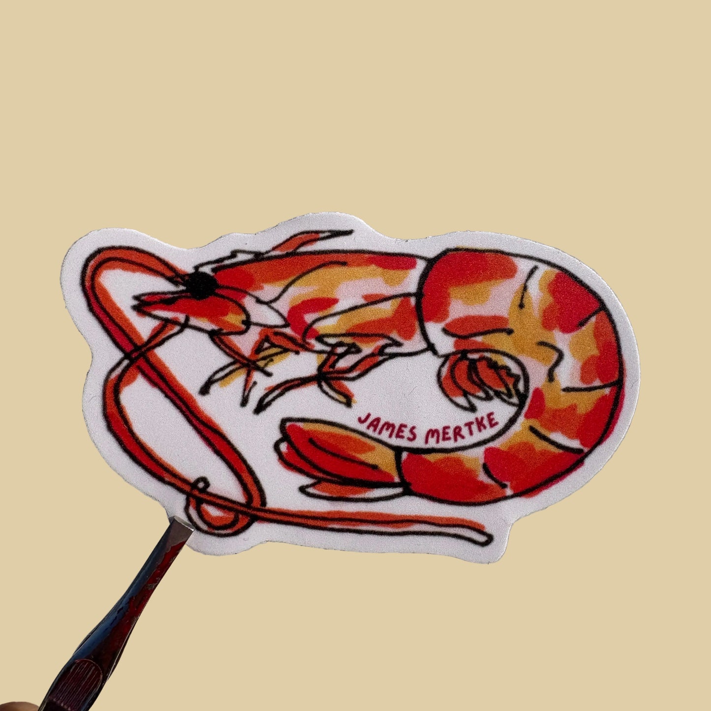 A sticker of a red and orange shrimp.